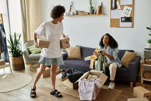 A couple joyfully sorts and enhances their clothing in a vibrant space. — Stock Photo