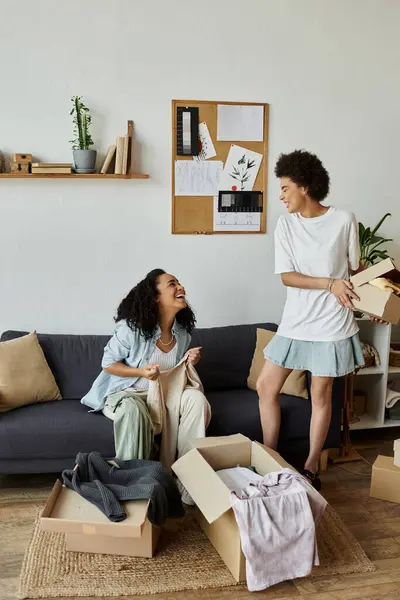 Couple laughs together while upcycling clothes in their creative home studio. — Stock Photo