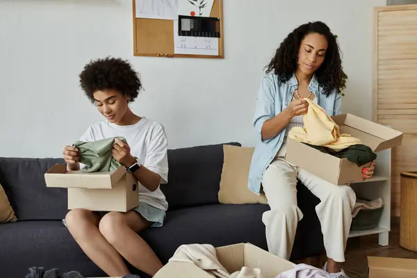 A couple joyfully transforms their clothes in a cozy indoor space. — Stock Photo