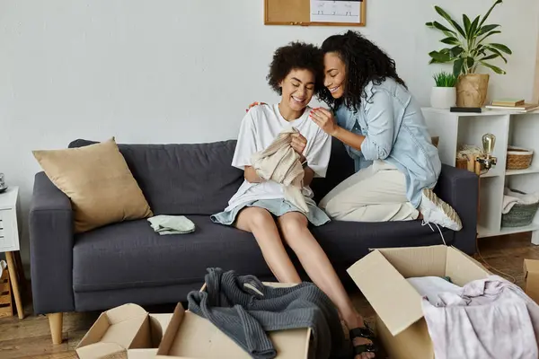 A couple enjoys creative clothing upcycling in their stylish home space. — Stock Photo