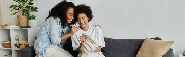 Lgbt couple joyfully transforms old clothes into new creations together. — Stock Photo