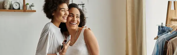 A joyful LGBT couple repurposes their clothes with laughter and love. — Stock Photo