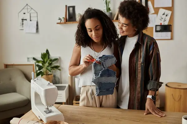 Two partners joyfully repurposing denim fabric to create unique fashion pieces. — Stock Photo