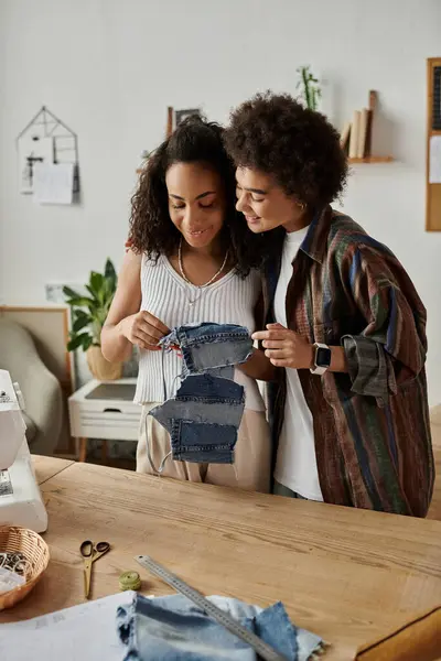 A loving couple joyfully transforms old clothes into stylish new outfits. — Stock Photo