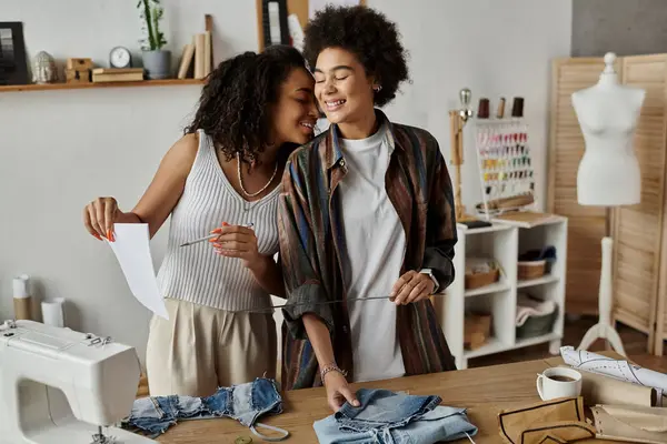 LGBT couple joyfully transforming their clothes in a vibrant creative workspace. — Stock Photo