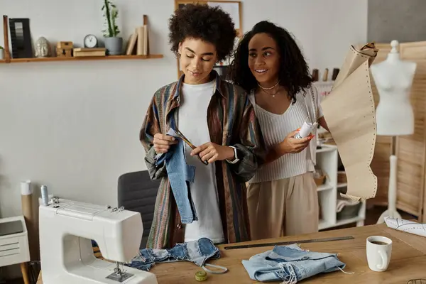 A couple joyfully repurposes their clothes in a stylish studio filled with creativity. — Stock Photo