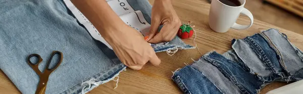 A woman skills her creativity by transforming old garments into new designs. — Stock Photo