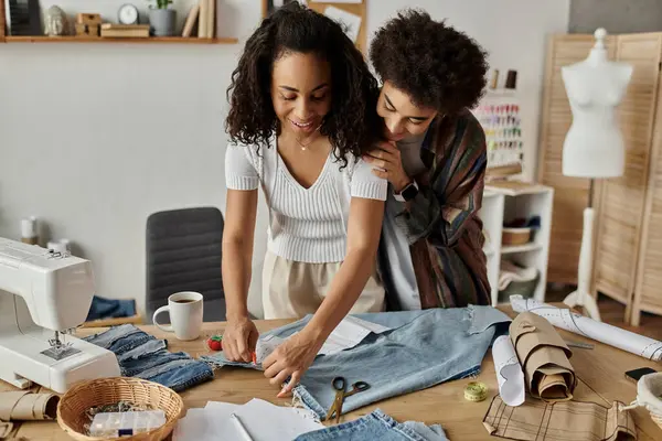 A couple transforms their clothes with care and creativity in a vibrant space. — Stock Photo