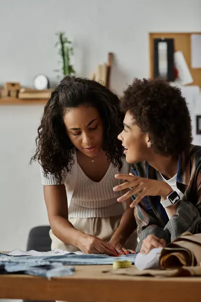 A creative couple collaborates on upcycling their clothes in a cozy workspace. — Stock Photo