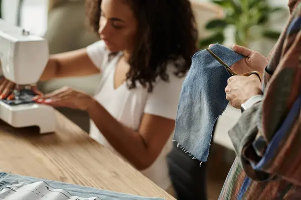 Couple joyfully transforms old garments into new creations. — Stock Photo