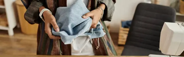 Woman joyfully transforms old garments into stylish new pieces. — Stock Photo