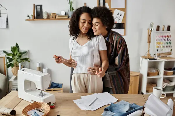 A loving couple transforms old garments into new styles with joy. — Stock Photo