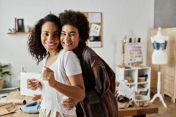 Two partners create unique outfits together in a cheerful workspace. — Stock Photo
