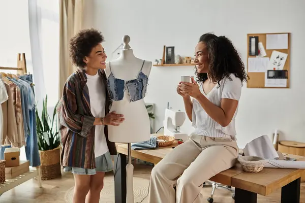 LGBT couple joyfully transforming clothes in their stylish home workshop. — Stock Photo