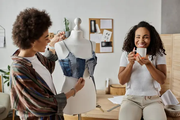 Couple joyfully crafts unique outfits from old clothing in their warm studio. — Stock Photo