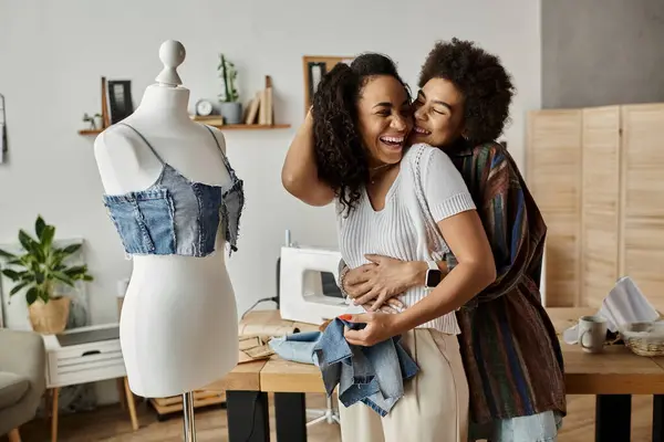 Loving couple joyfully transforms clothes in a vibrant workshop. — Stock Photo