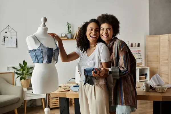 A happy couple upcycles clothing while enjoying each other's company. — Stock Photo
