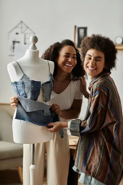 A joyful couple designs and transforms old clothing pieces. — Stock Photo