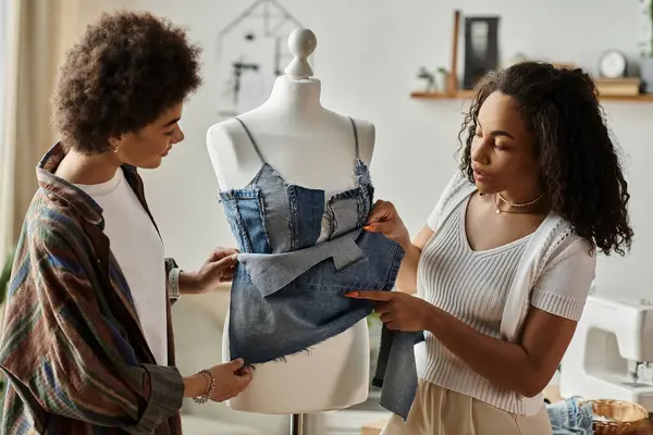 A couple transforms old garments into stylish new pieces with love and creativity. — Stock Photo