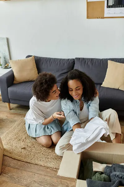 Couple joyfully transforms old clothes into new treasures together. — Stock Photo