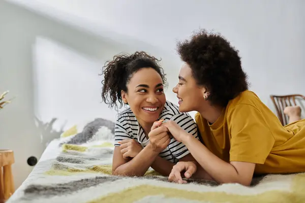 A couple shares laughter and affection while relaxing together indoors. — Stock Photo