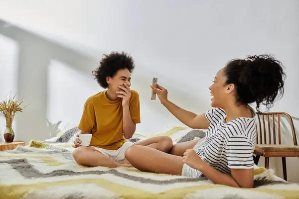 A loving couple enjoys playful laughter and cozy moments together indoors. — Stock Photo
