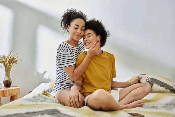 A loving couple shares a tender embrace on a sunlit bed. — Stock Photo