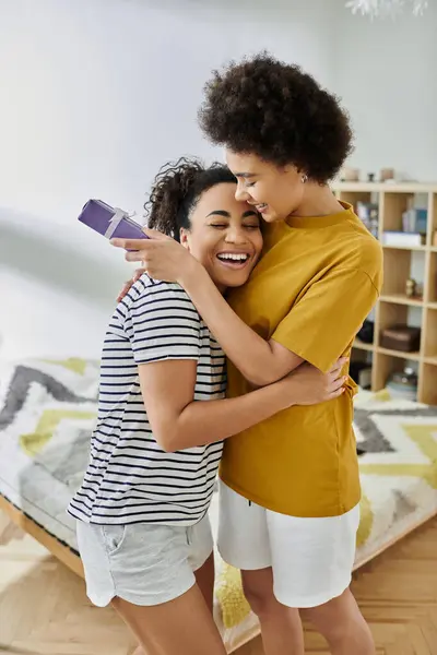 A loving couple enjoys a lighthearted moment while cuddling at home. — Stock Photo