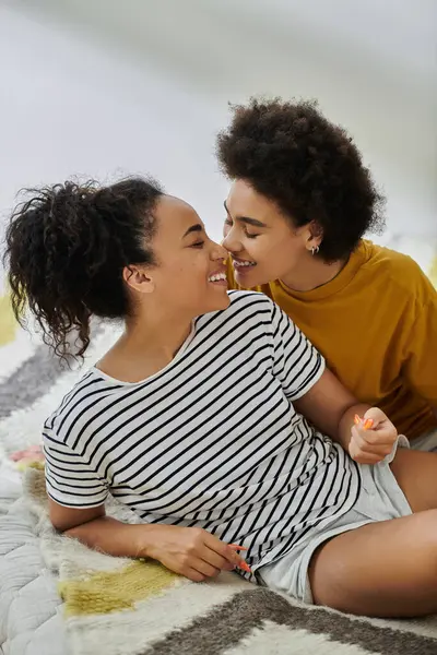 Loving couple enjoys tender moments while lounging comfortably together. — Stock Photo
