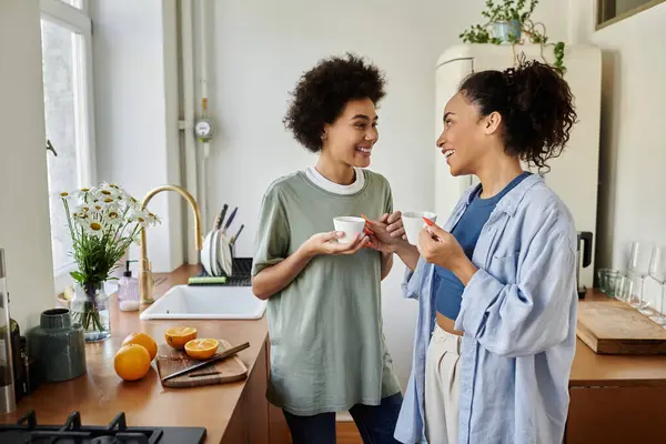 Two women enjoy intimate moments over coffee at home. — Stock Photo