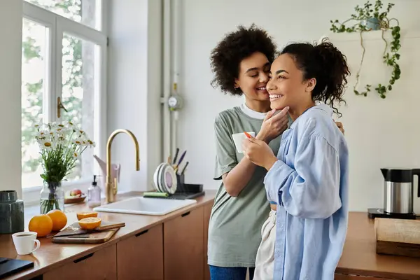 Una pareja cariñosa comparte la risa mientras cocinan juntos en casa. - foto de stock