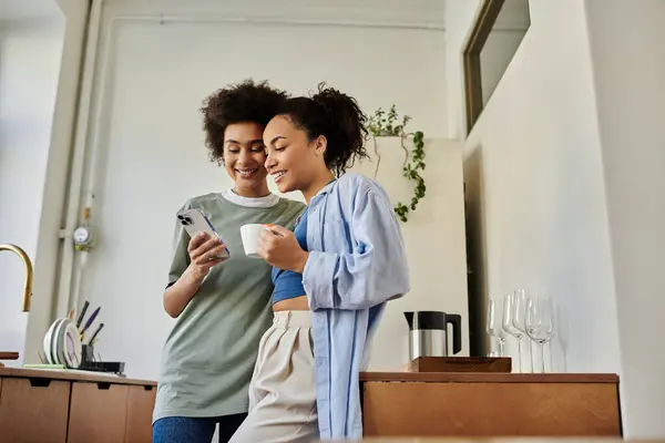 Two women share a joyful moment while relaxing together over coffee. — Stock Photo