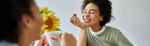 A happy couple enjoys snacks and each other's company in a cozy setting. — Stock Photo