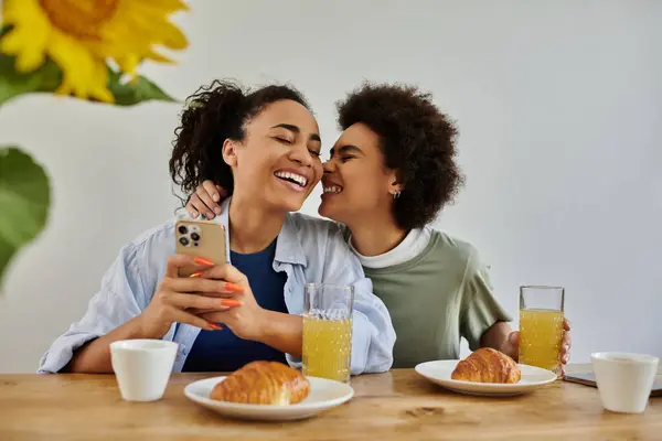 Couple enjoys breakfast together, sharing smiles and affection in a cozy home setting. — Stock Photo