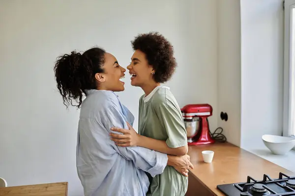 A couple shares laughter and affection while enjoying their cozy kitchen. — Stock Photo