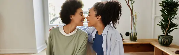 A happy couple leans in to share a tender moment at home. — Stock Photo