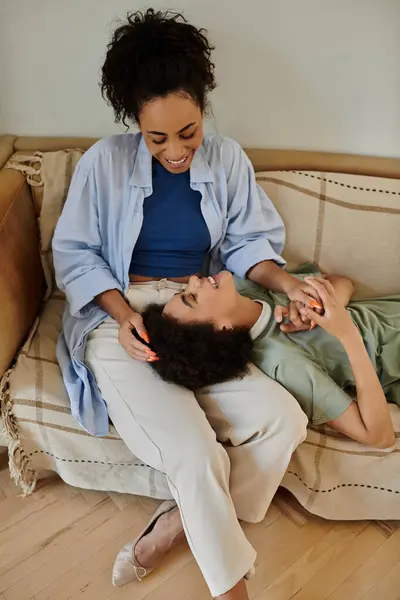 Loving couple shares laughter and affection while relaxing comfortably. — Stock Photo