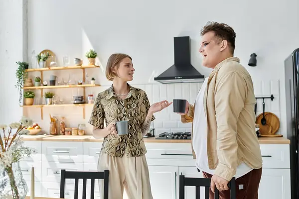 Two friends share a moment over coffee in a warm, inviting kitchen. — Stock Photo