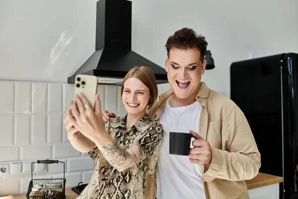 Cheerful friends take a playful selfie in a modern kitchen setting. — Stock Photo