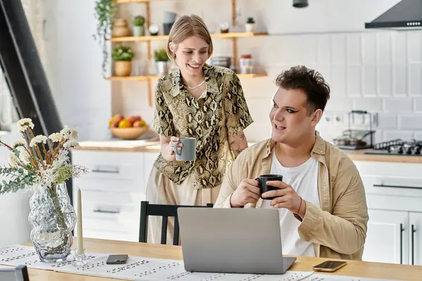 Two friends share lively conversation, sipping coffee in a chic kitchen. — Stock Photo