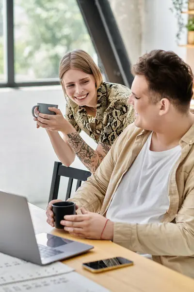 Two friends share laughs and coffee in a warm, inviting home environment. — Stock Photo