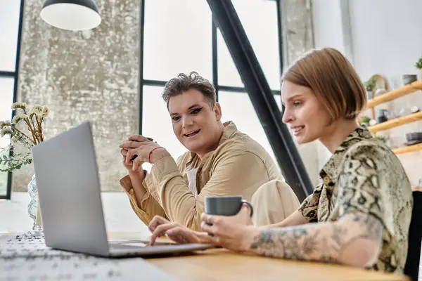 Two friends share laughter and moments over a laptop in a cozy home setting. — Stock Photo