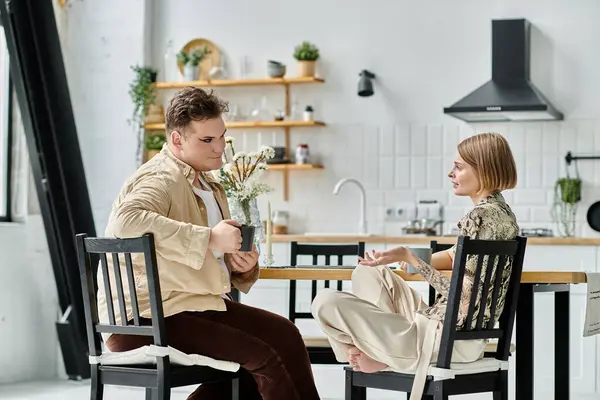 Two friends share a heartfelt conversation over coffee in a cozy kitchen. — Stock Photo