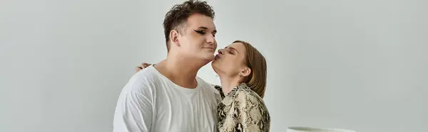 A queer person receives a gentle kiss from a friend in a cozy home atmosphere. — Stock Photo