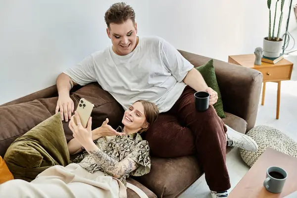 Two friends share smiles and a relaxed moment while taking selfies together. — Stock Photo