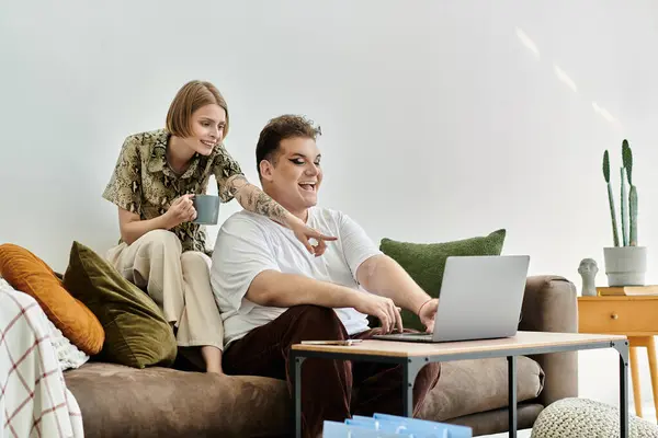 Two friends share joy and creativity while working on a laptop at home. — Stock Photo