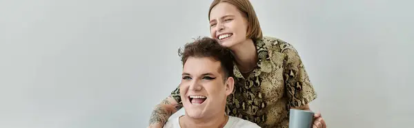 Two friends share laughter and joy during a cozy gathering in their living space. — Stock Photo
