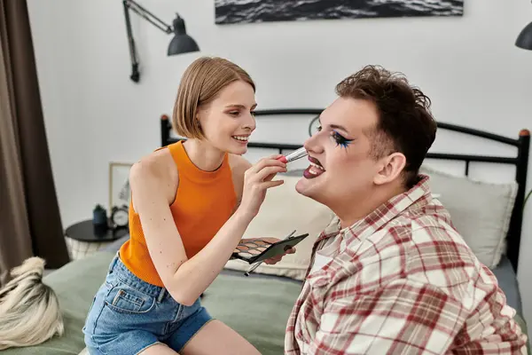 Creating vibrant looks during a makeup session together. — Stock Photo