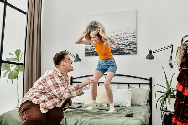 Two friends joyfully interacting in a stylish bedroom setting. — Stock Photo