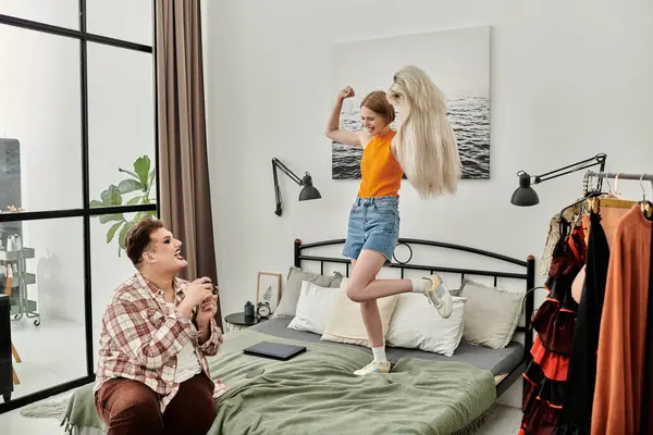 Two friends enjoy a joyful moment in a stylish bedroom. — Stock Photo